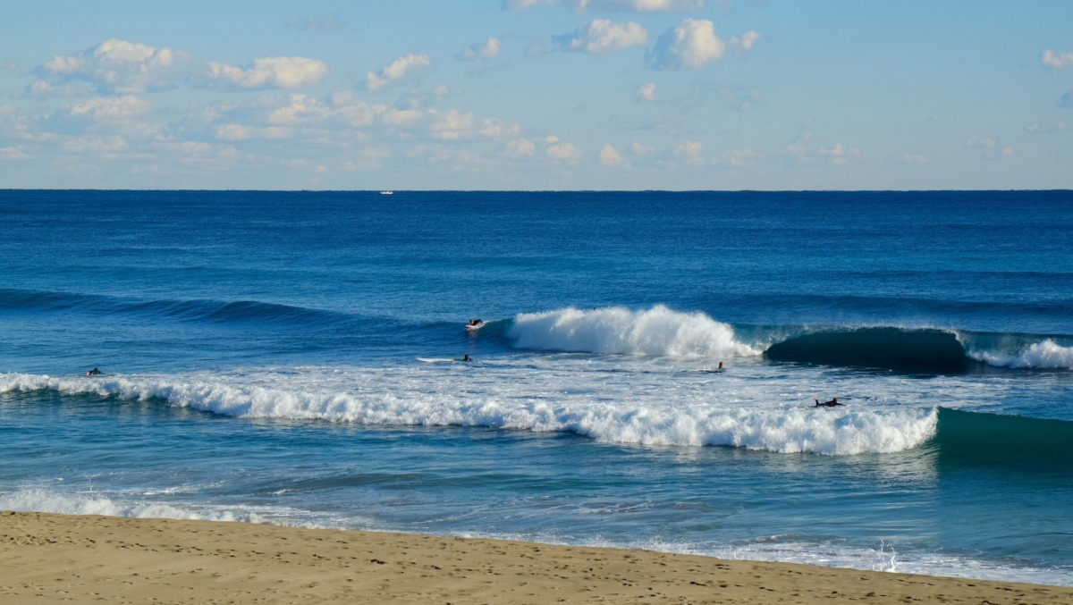 person surfing on sea waves during daytime